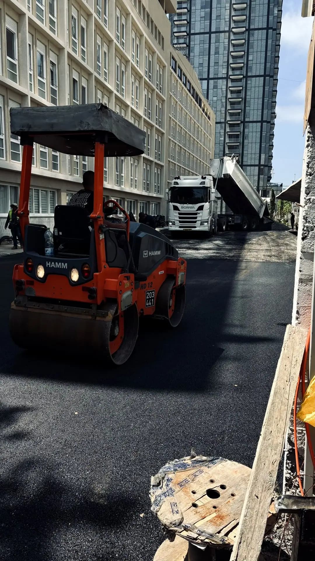 מכבש אספלט בפעולה במהלך סלילת החניון מחדש